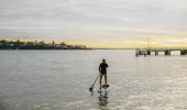 Man enjoying a morning of stand up paddleboarding in Port Hacking near Bundeena Wharf, Bundeena